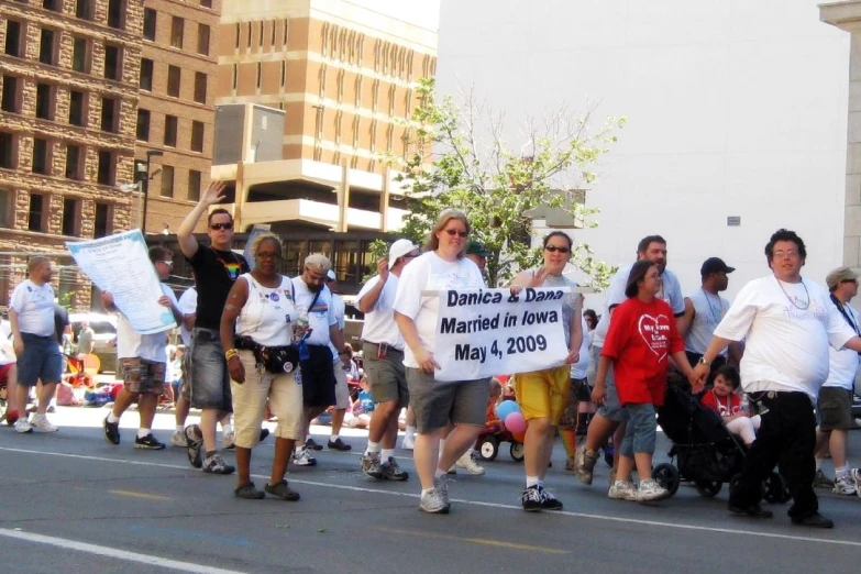 a group of people marching down the street in a parade