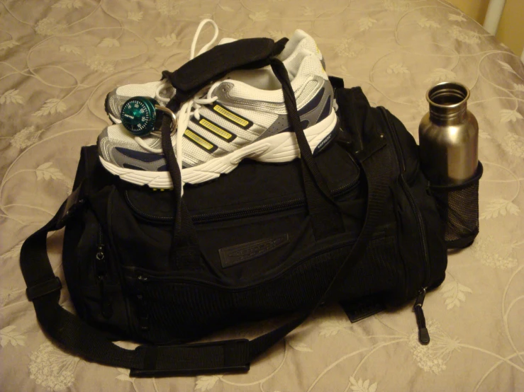 a sports bag sitting on top of a bed