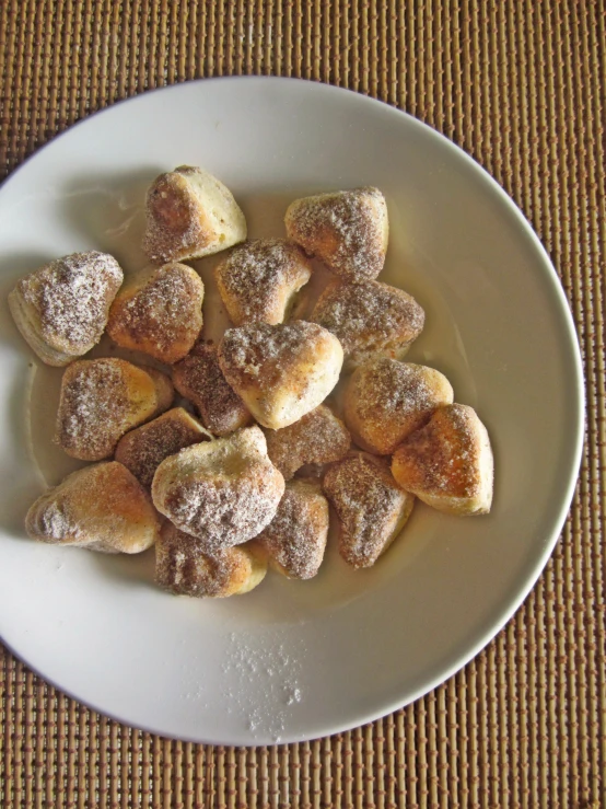 several heart shaped powdered sugar pastries sitting on a plate