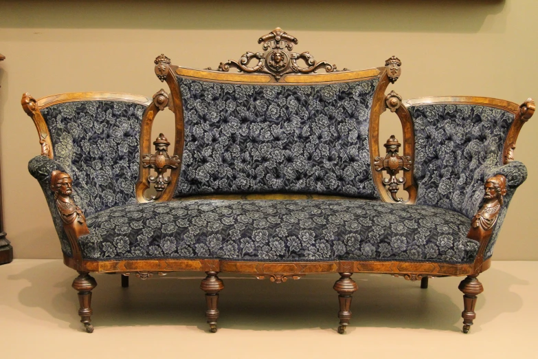 two wooden and blue patterned fabric couches