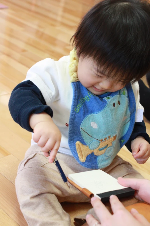 a young child has his picture taken from a phone