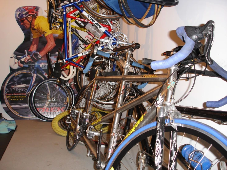 many bikes are sitting up against a wall