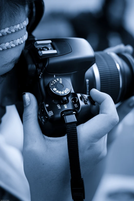 a black and white pograph of a camera being held