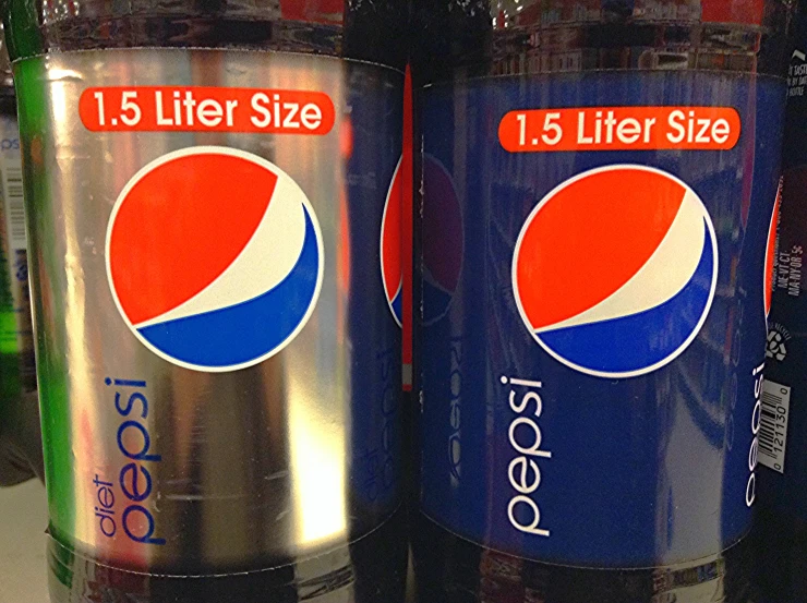three cans of pepsi soda on display with their labels on them