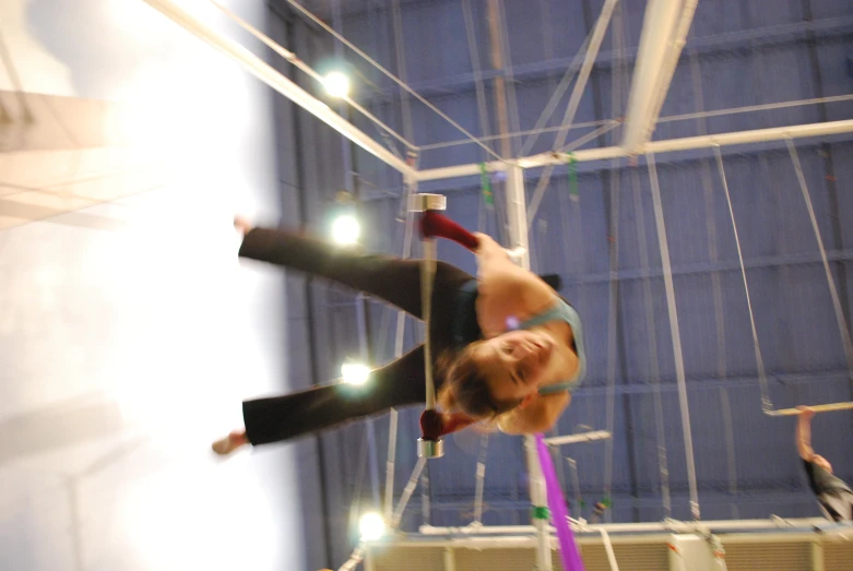 woman upside down upside down on bars in an indoor gym