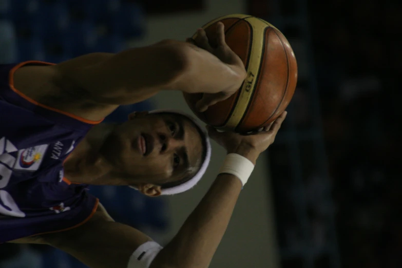 a man is shooting a basketball in the air