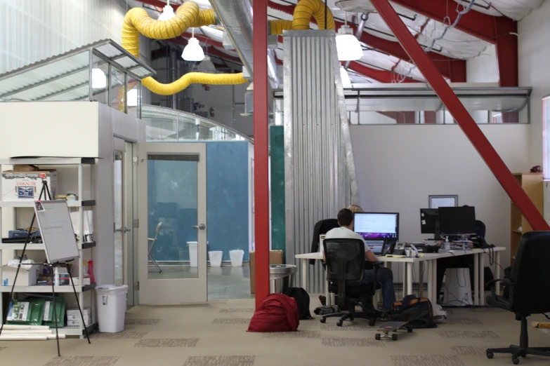 a person sitting in an office with a yellow thing