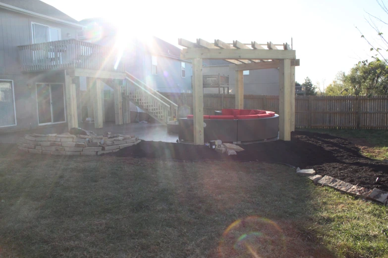 a backyard with a  tub and large rocks