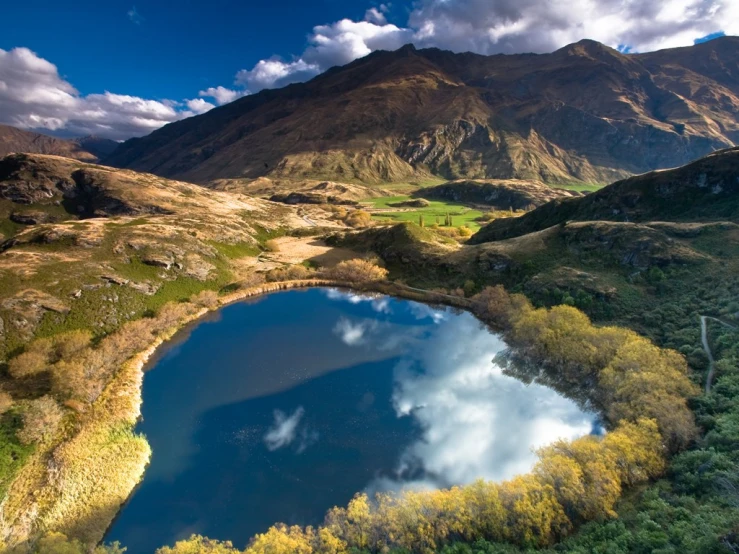 the mountains are reflected in this blue lake