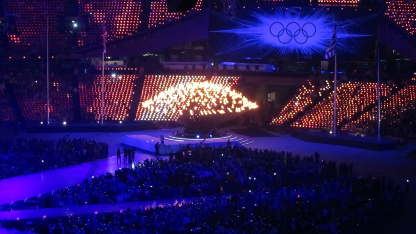 several performers in a large crowd on a stage