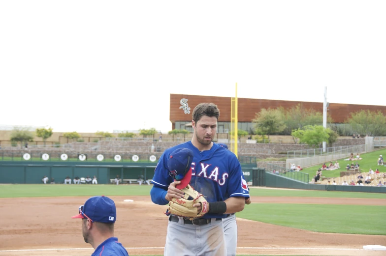 a professional baseball player stands next to his pitcher