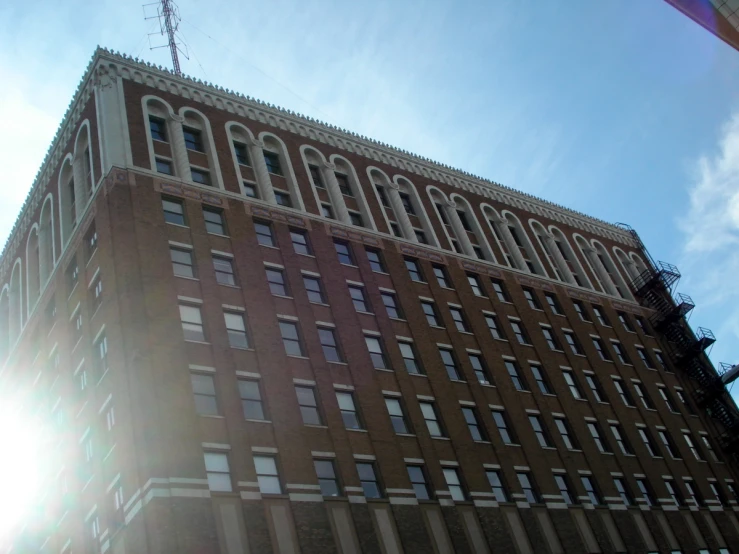 the sun shines brightly above a building in new york city