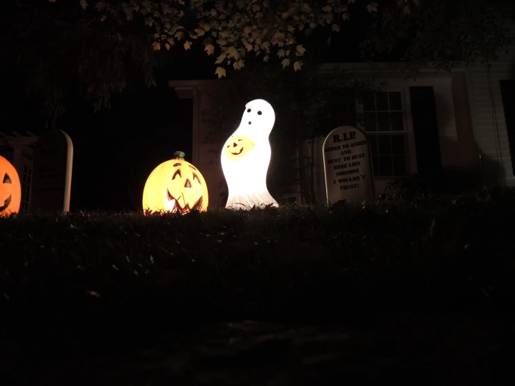 a couple of jack o lantern pumpkins on the ground