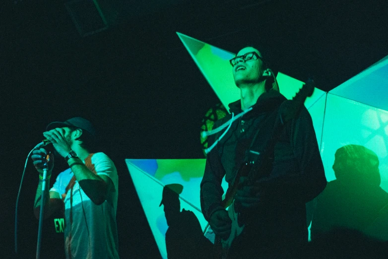 a man standing in front of a microphone on a stage