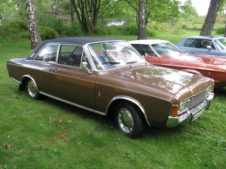 a car parked on grass with other cars