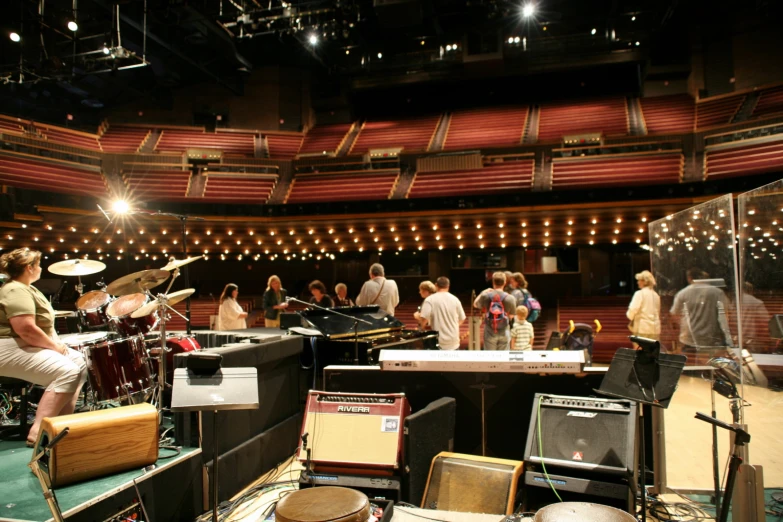 people in a recording studio playing music instruments and drums