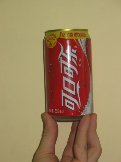 a can of diet coke in a person's hand