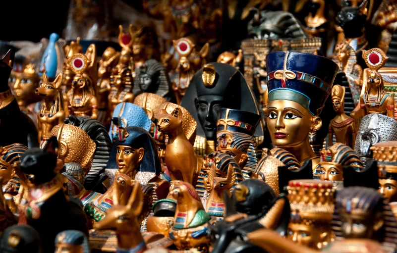 an assortment of egyptian figurines and other decorations