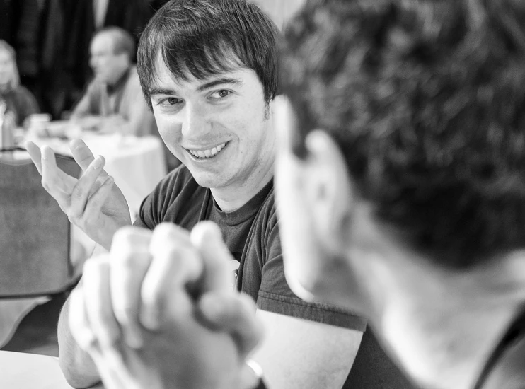 the young man smiles while showing off his new finger