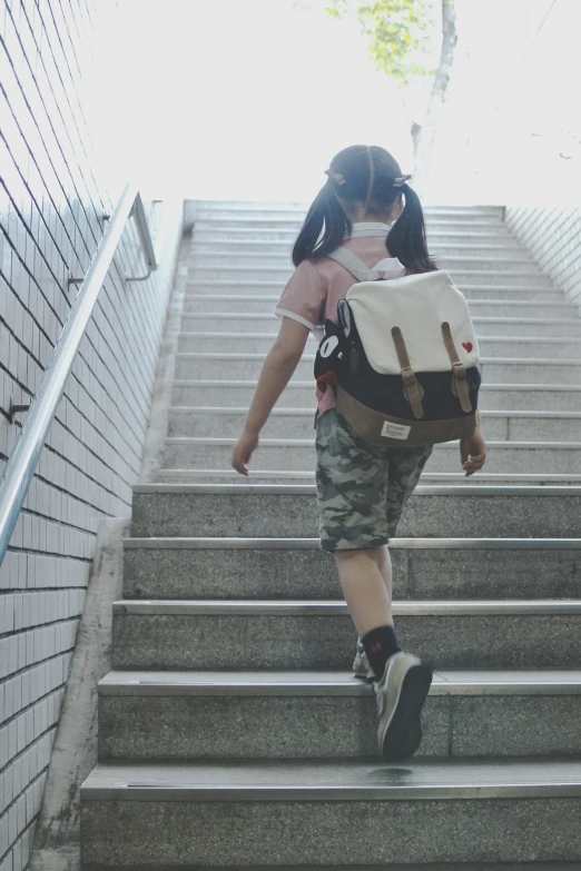 a person walking down a flight of stairs carrying a backpack