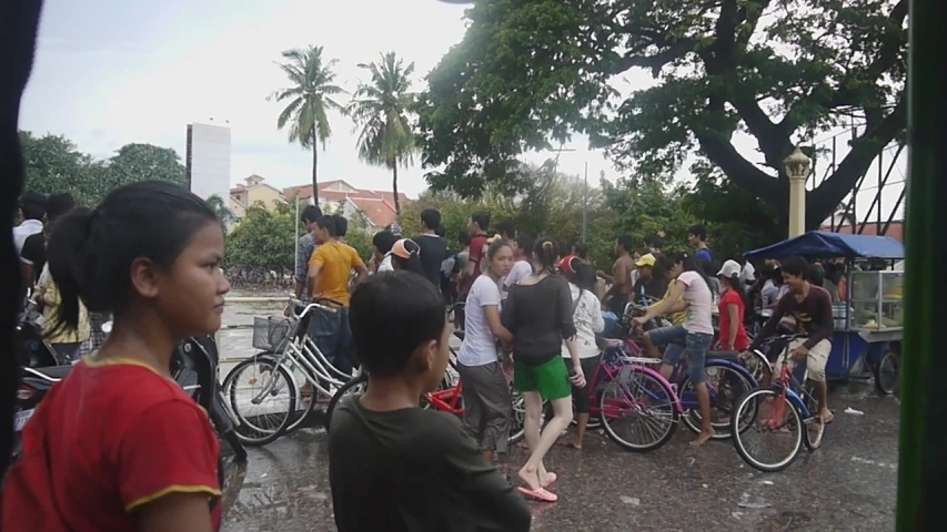 a group of people with bicycles on a street