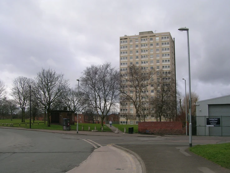 a very large building is seen near some street lights