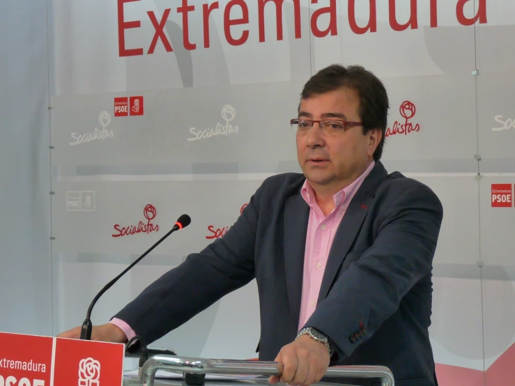 a man standing behind a podium giving a presentation