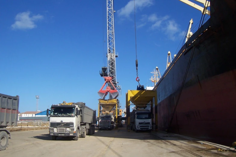 a white truck and crane in a parking lot