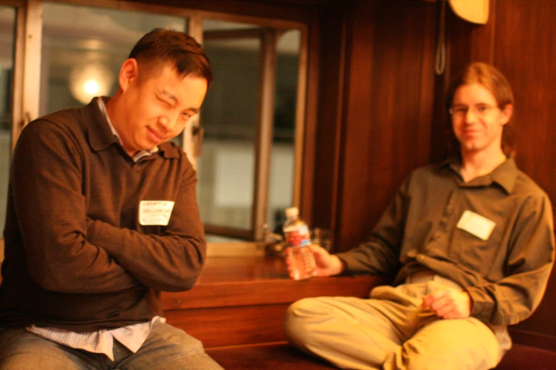 a man sitting on a bench next to a young woman