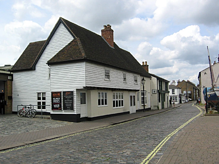 a white building with windows next to a street