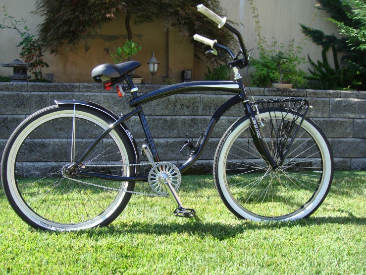 the bike is leaning against the stone wall