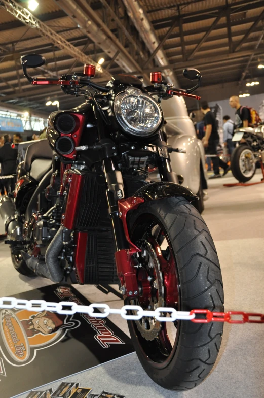 a motorcycle displayed in a garage and its chain on the back