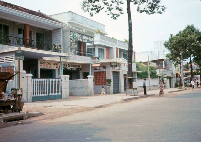 a person walking along a street next to parked cars