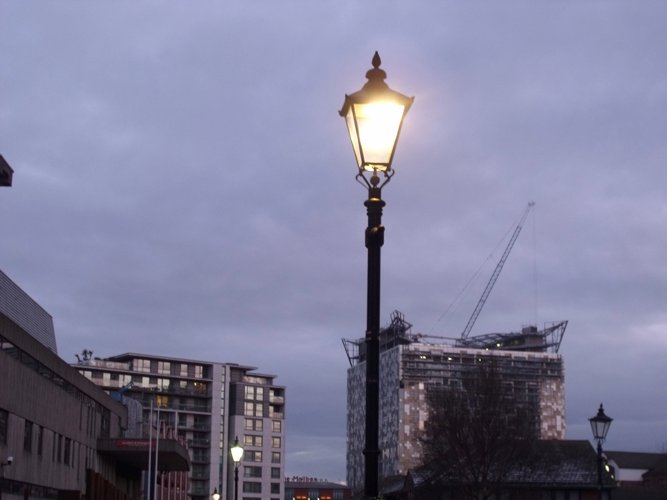 a large street light next to buildings and lights