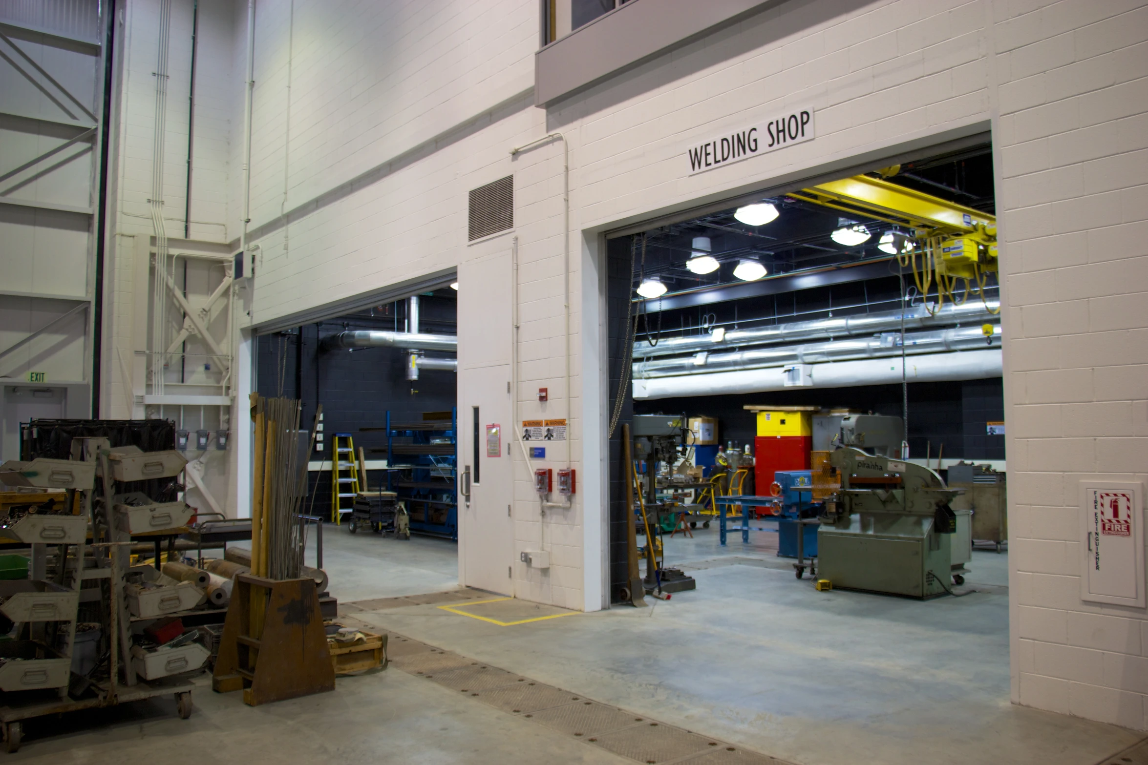 a large, white warehouse with large light fixtures