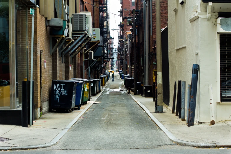 narrow alley alleyway with trashcans and garbage cans