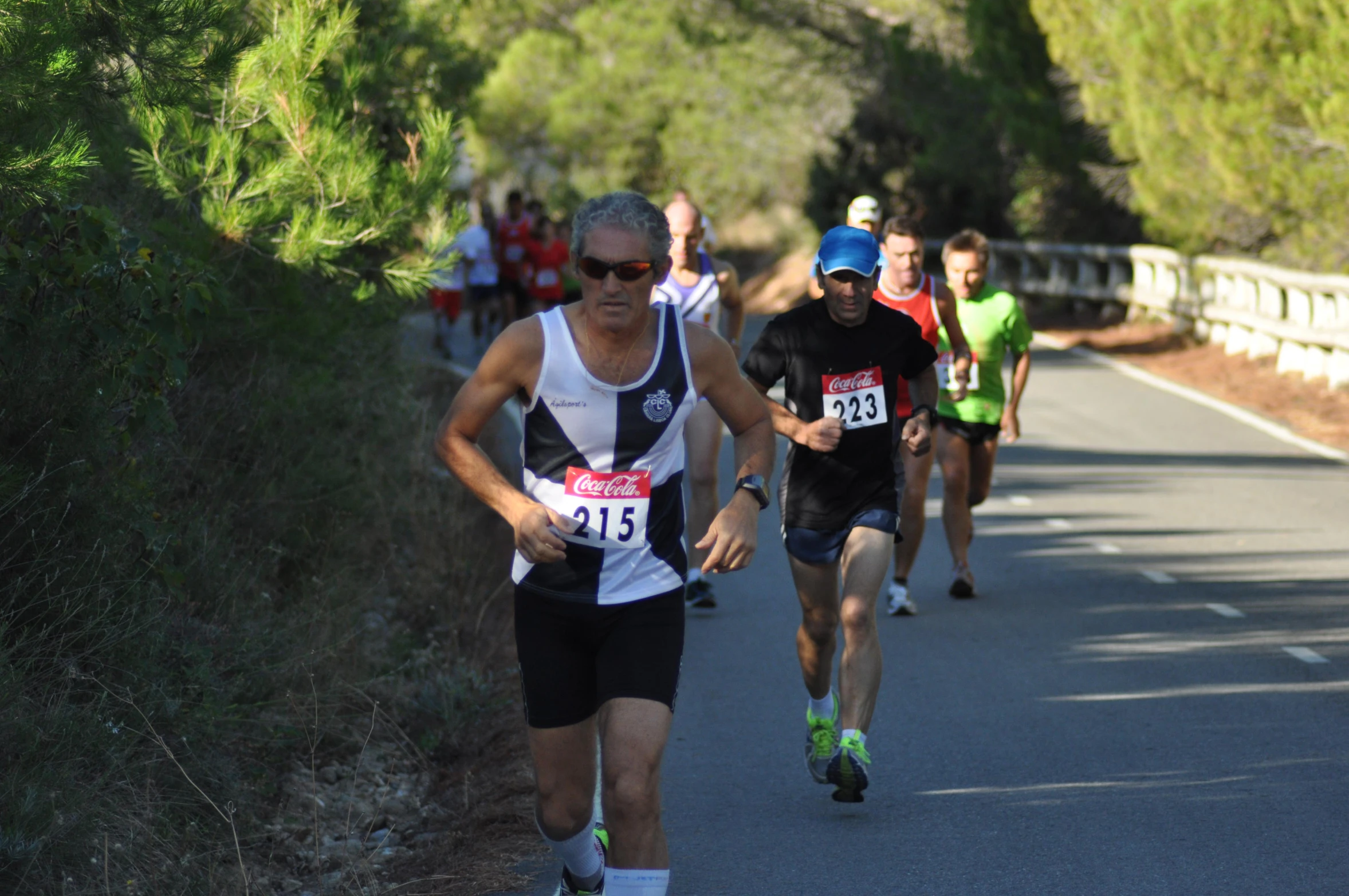 a couple of men running on the road