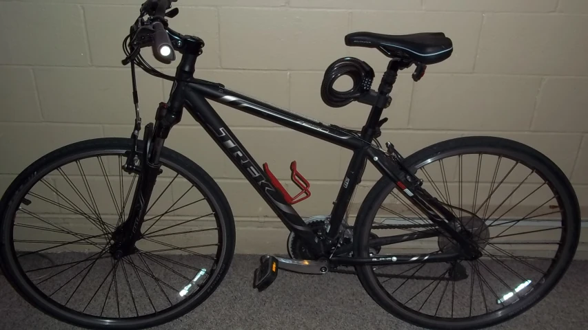 the bicycle is parked in front of a brick wall