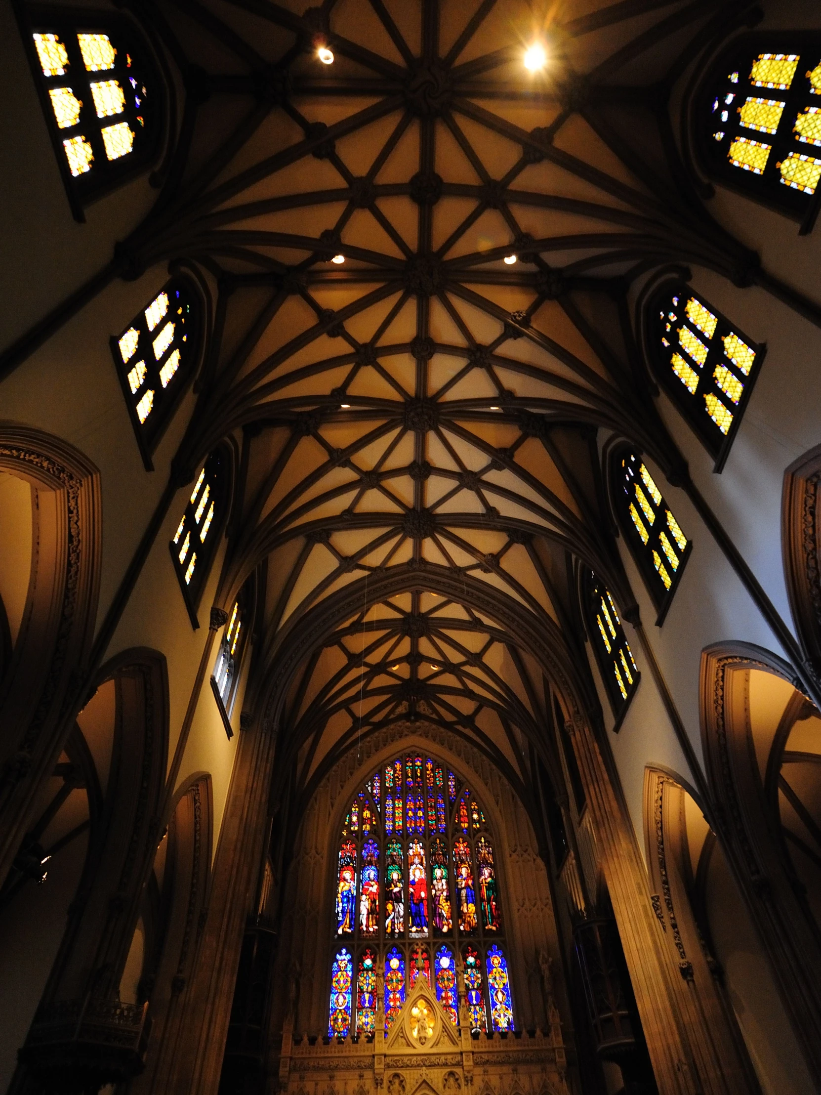 a tall church with arched ceilings and stained glass windows