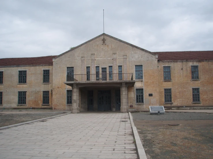 an old brick building with a bench on the side