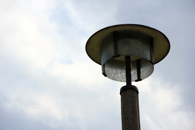 a street light pole against a blue sky