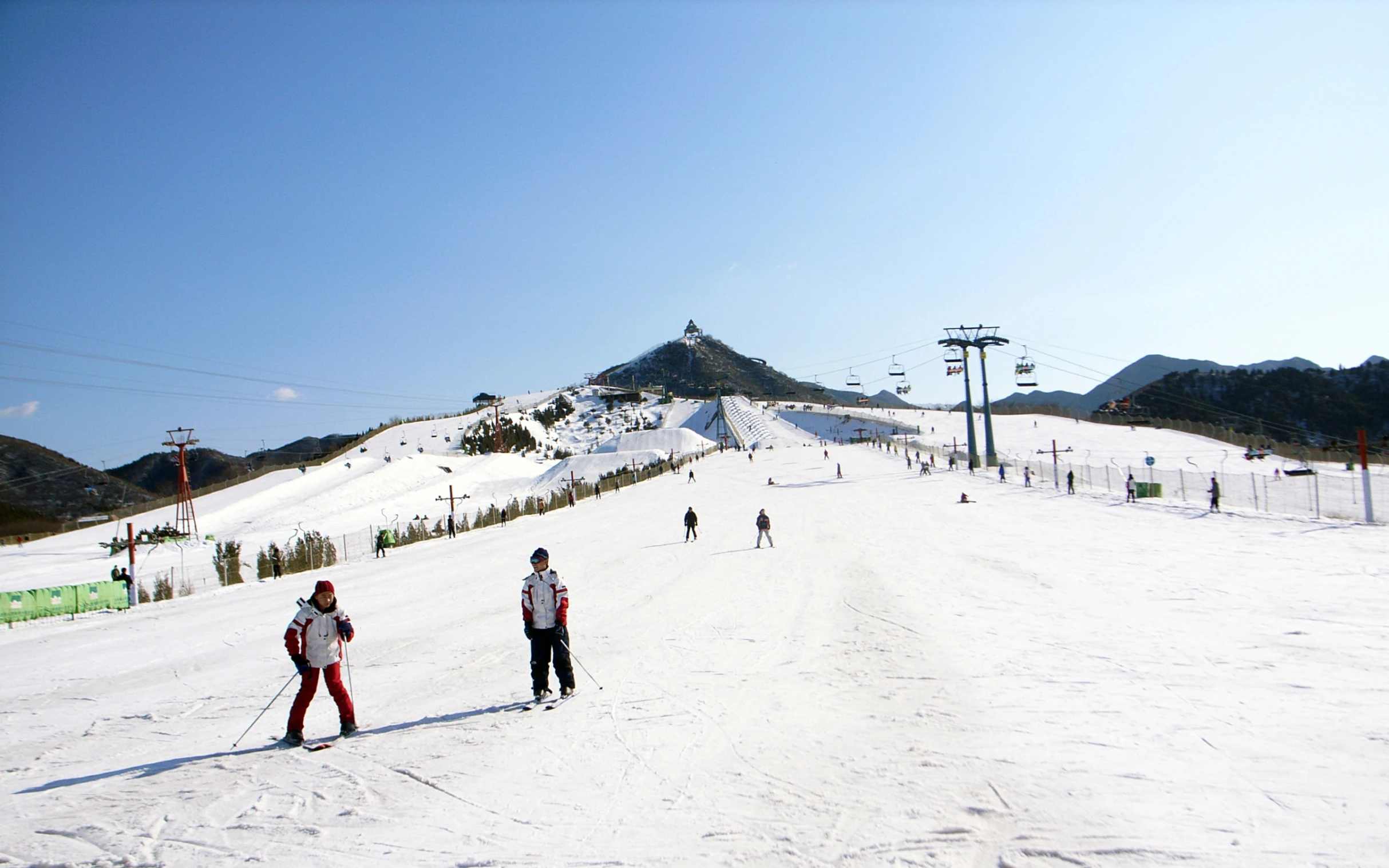 a group of people standing on top of a snow covered slope