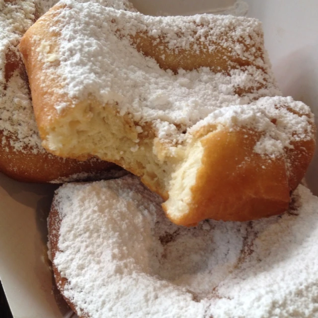 powdered sugar covered pastries sit on a table