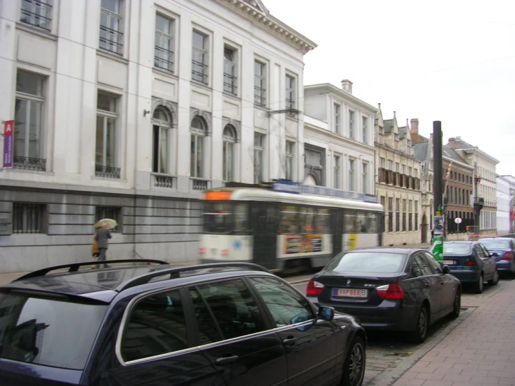 a city street with cars stopped near many buildings