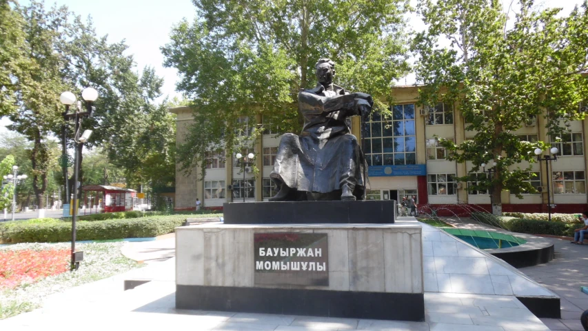 a statue sitting outside with trees in the background