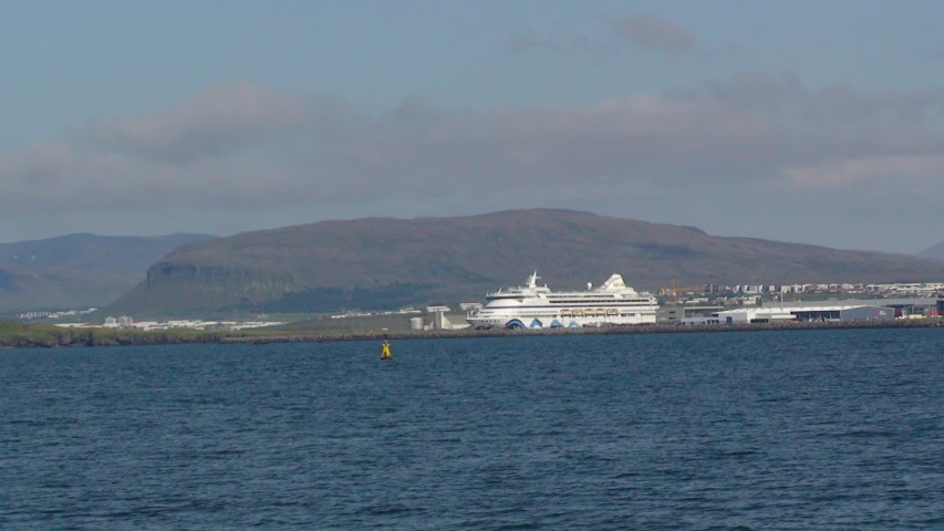 the cruise ship is docked next to the ocean