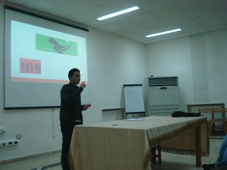 a man standing in front of a projection screen