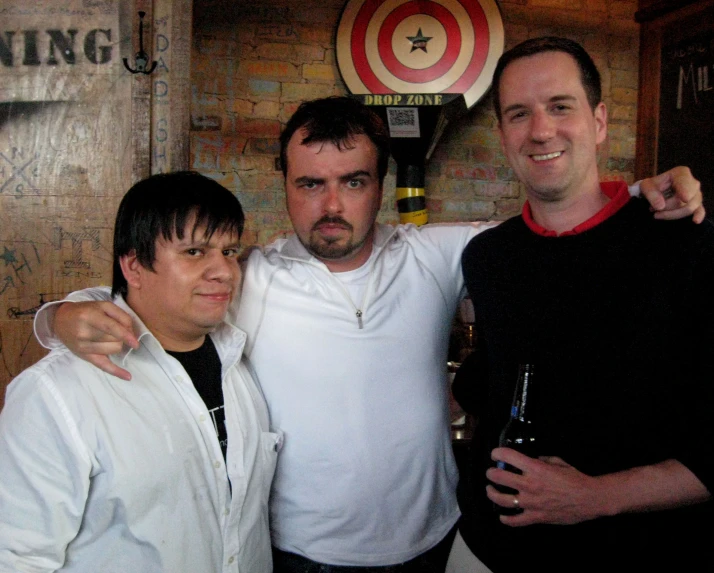 three men smiling and posing for the camera