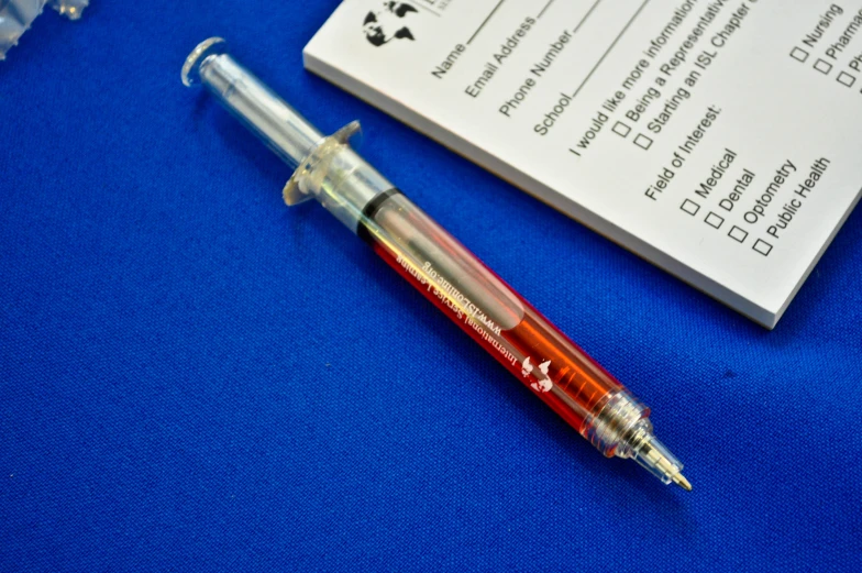 a pen with a white background next to a medical check card