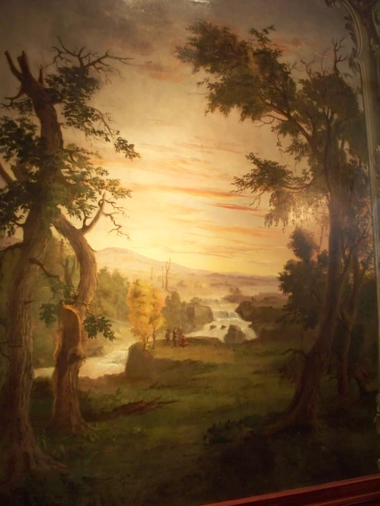 painting of wooded scenery on the wall above a fireplace